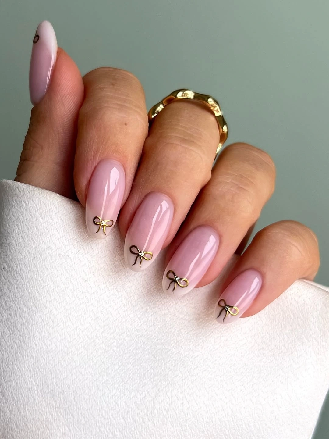 Medium almond nails with brown tips and tiny gold accents