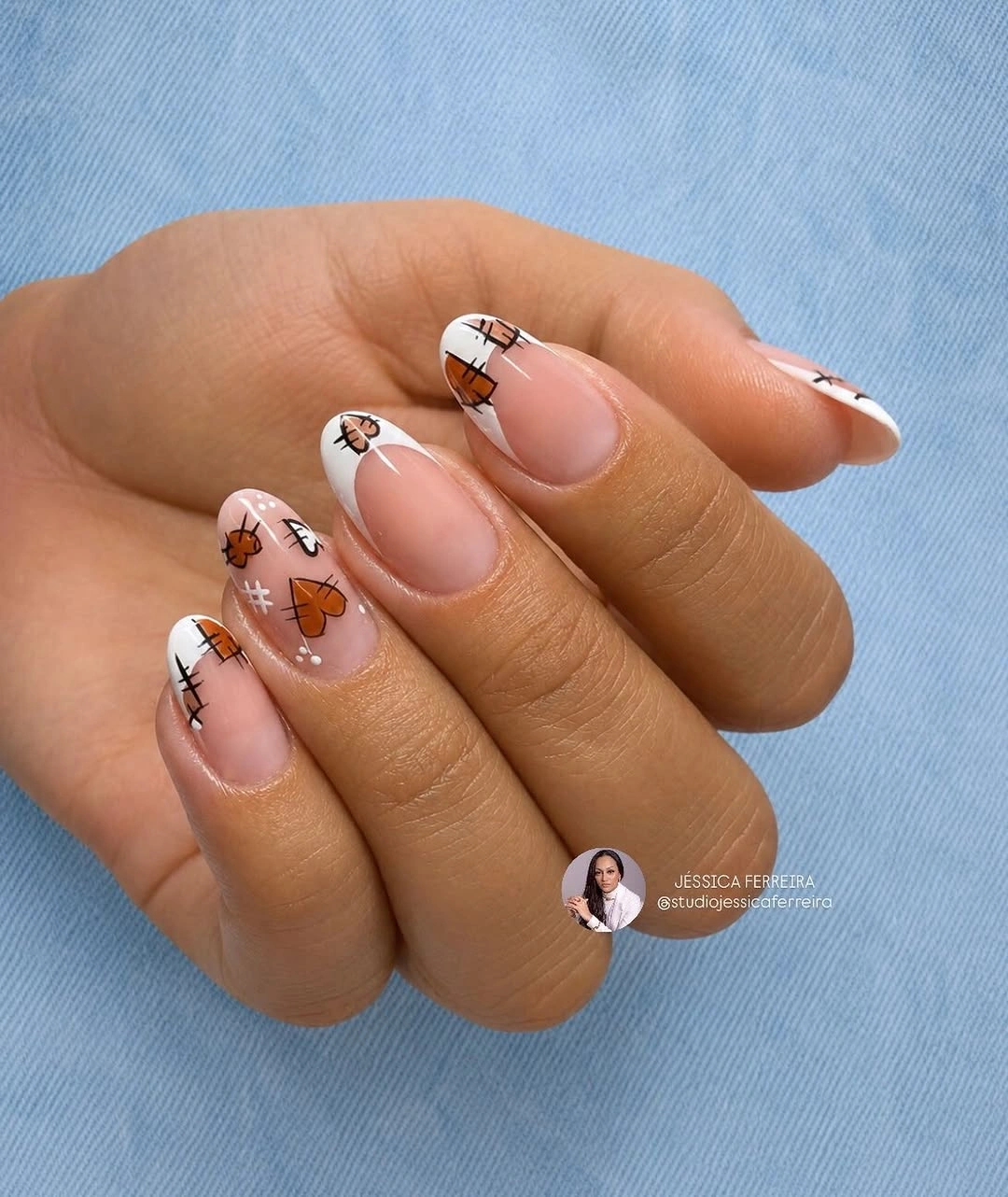 Medium almond nude nails with tiny autumn sketches