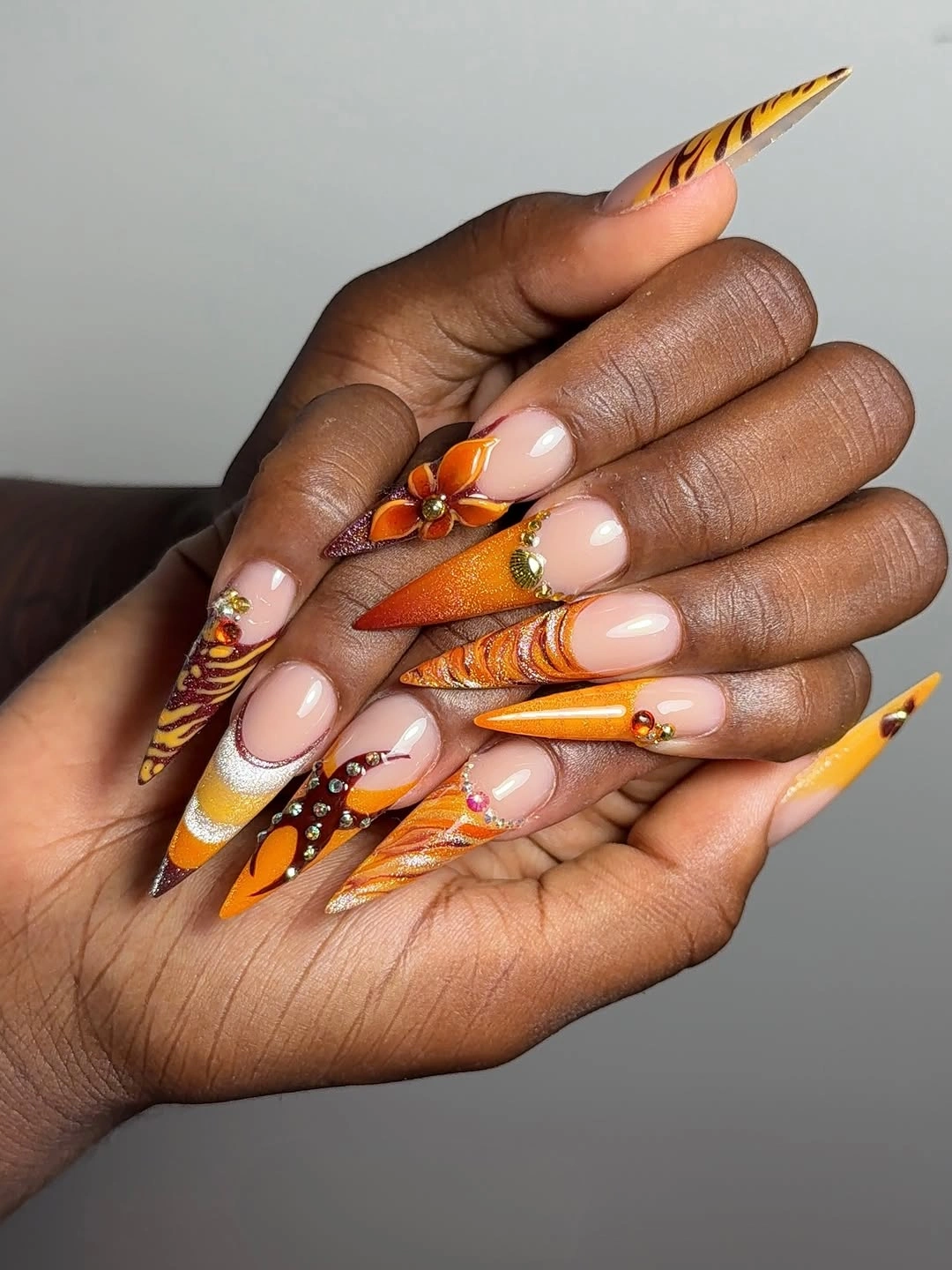 Long stiletto orange white and amber pointed accents