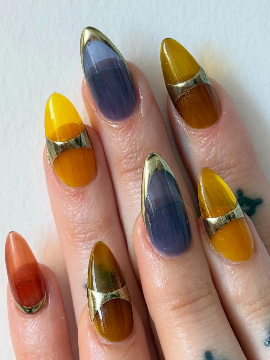 Medium almond nails with mustard blue and rust color panels