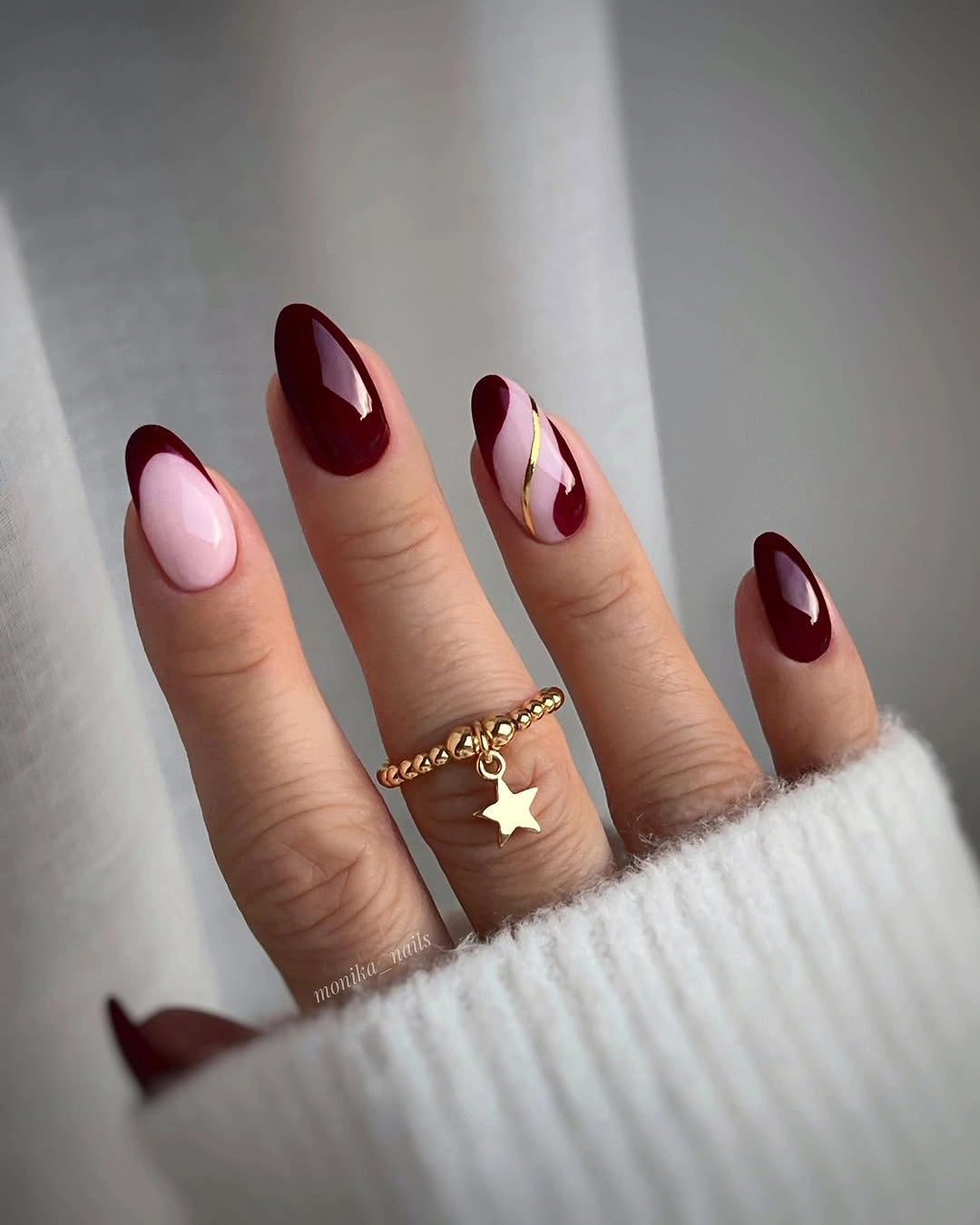 Glossy wine almond nails with blush accent