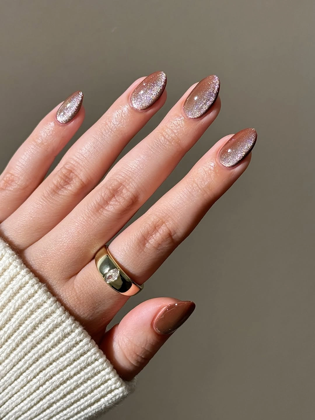Sparkly neutral almond nails with cocoa accent