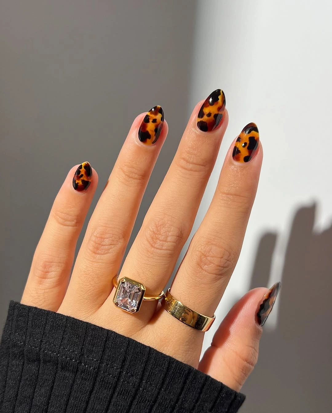 Orange leopard almond nails with black spots