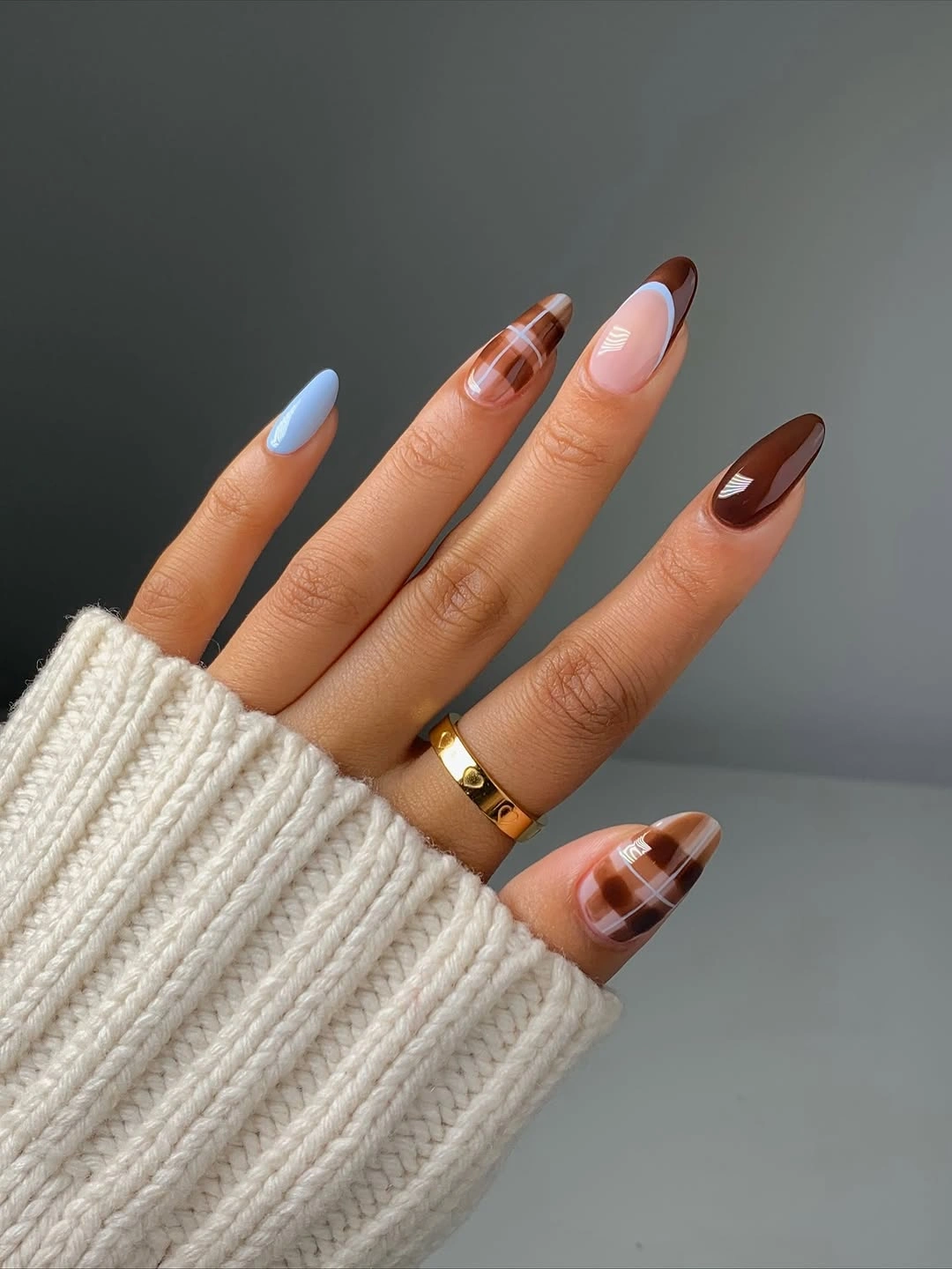 Pastel blue nails with brown patchwork accents
