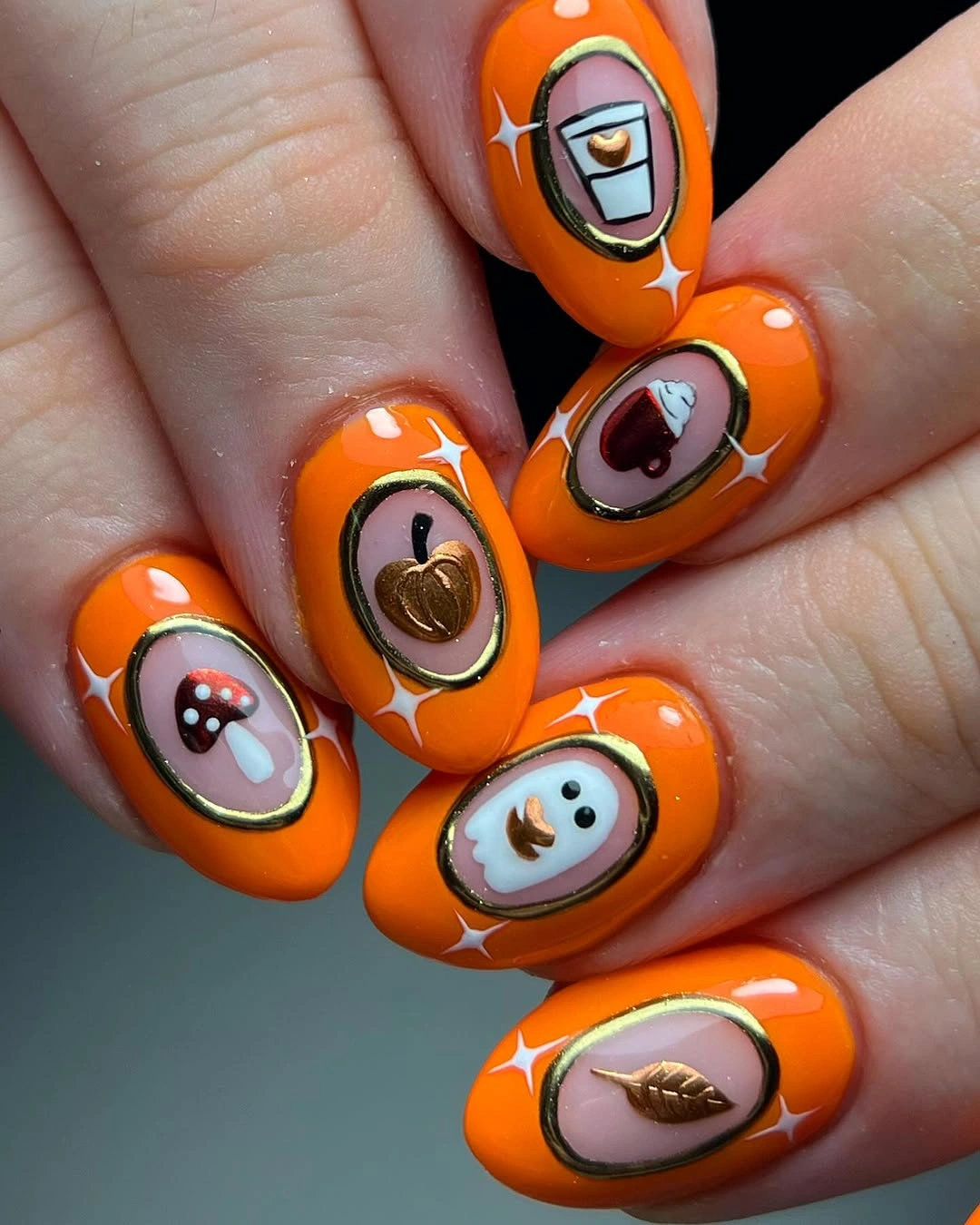 Bright orange nails with framed mini motifs