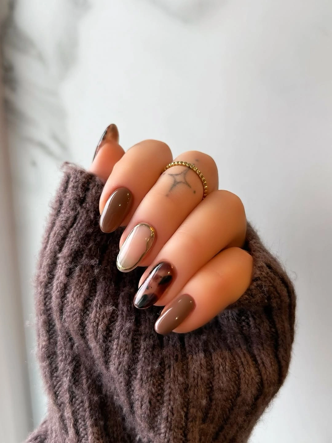 Smoky brown almond nails with caramel accents