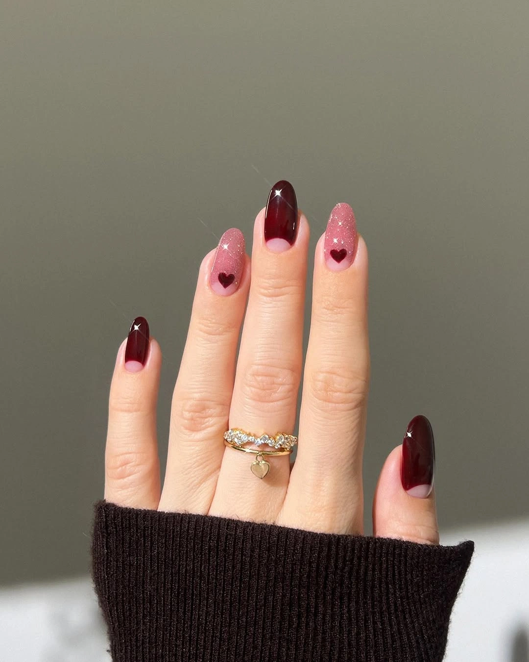 Burgundy almond nails with blush heart accents