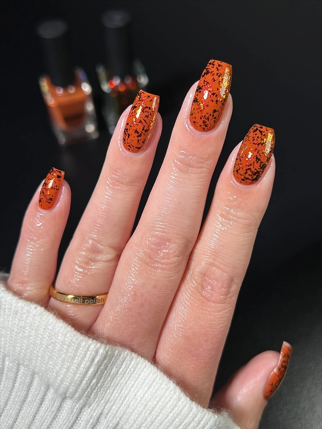 Medium square nails with burnt orange tips and dark speckles