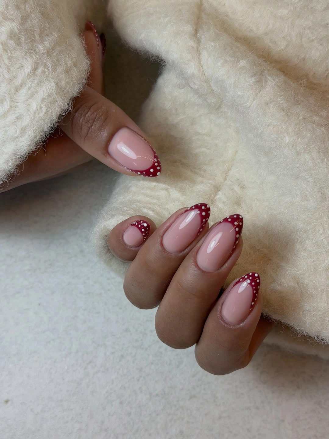Medium almond nails with berry red dotted French tips