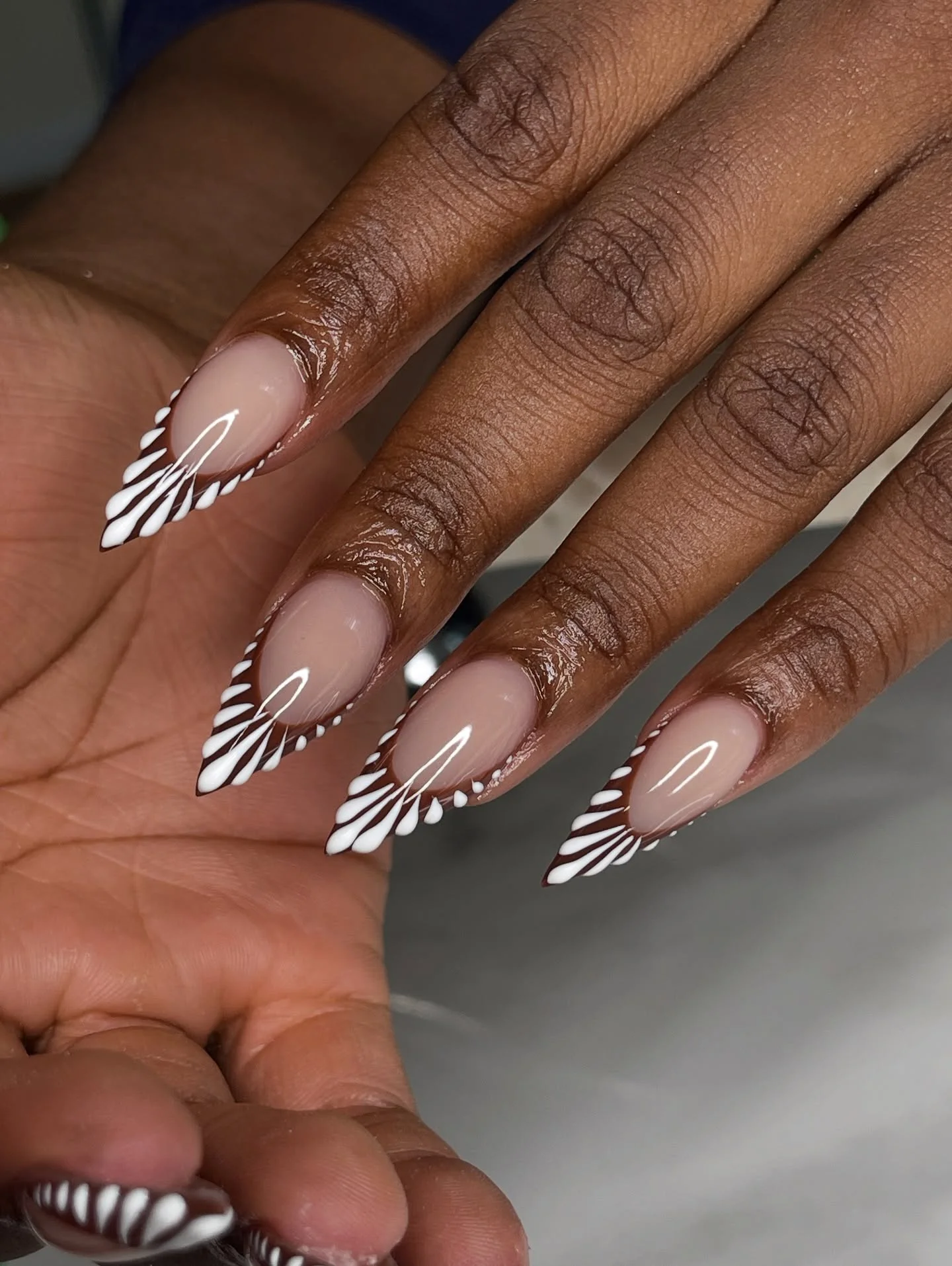 Long almond nails with radiating black and white tip lines