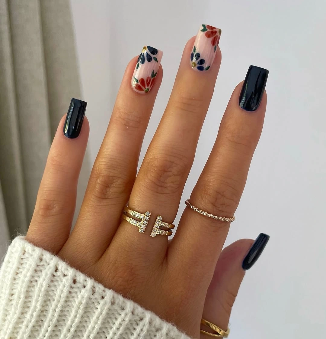 Long square nails with dark tips and small colorful accents