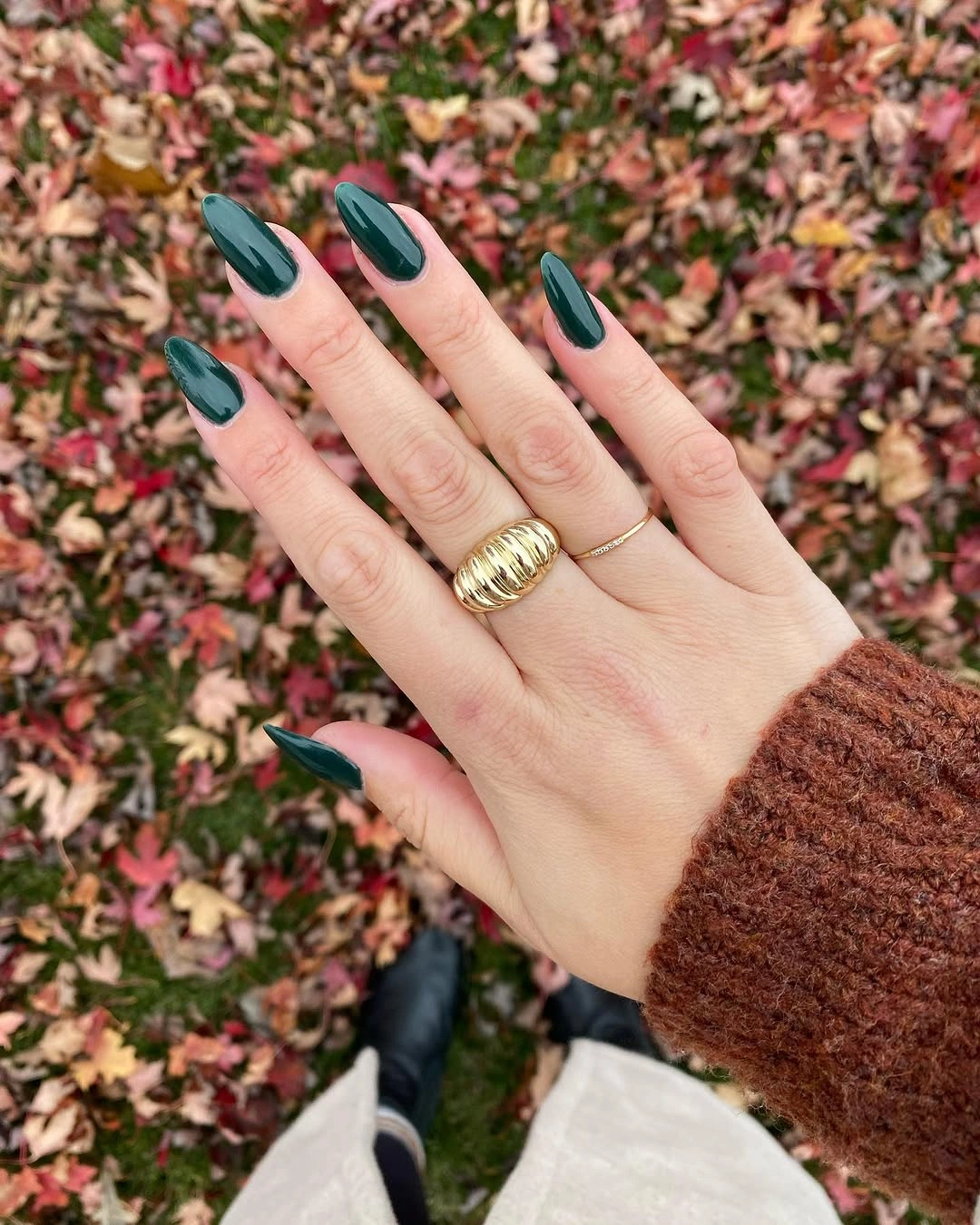 Long almond nails with deep teal French tips and pale base