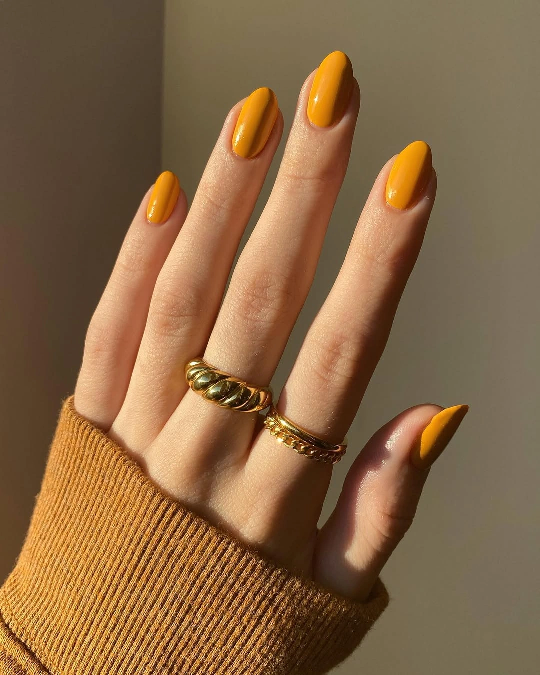 Medium almond nails in one glossy mustard yellow shade