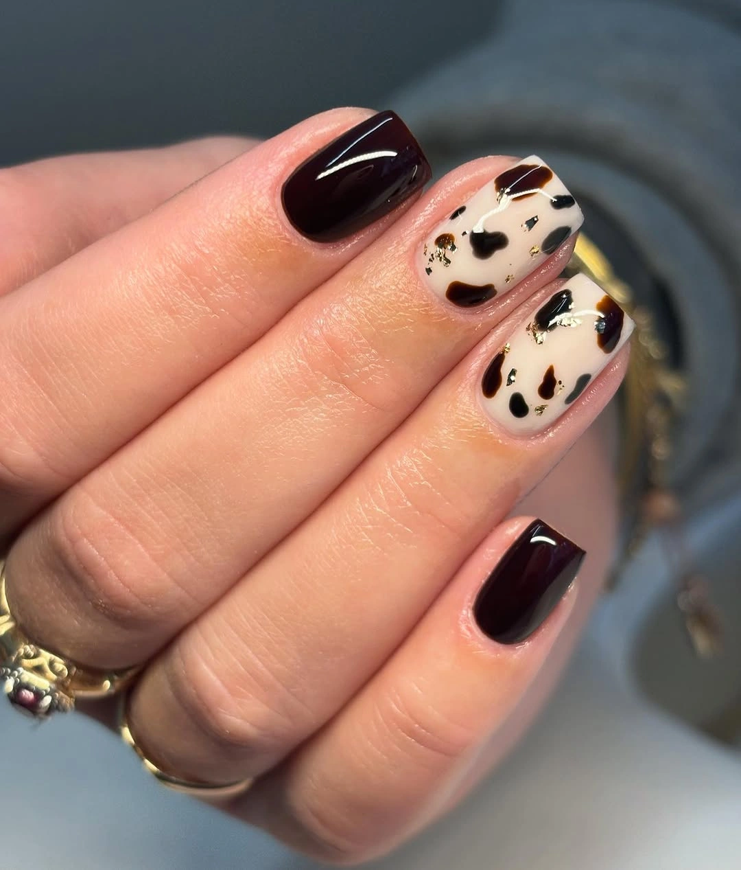 Short square green nails with black and white striped accents