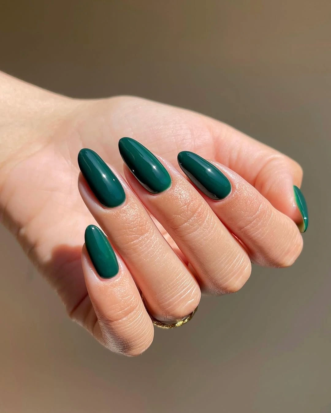 Glossy forest green almond nails for fall