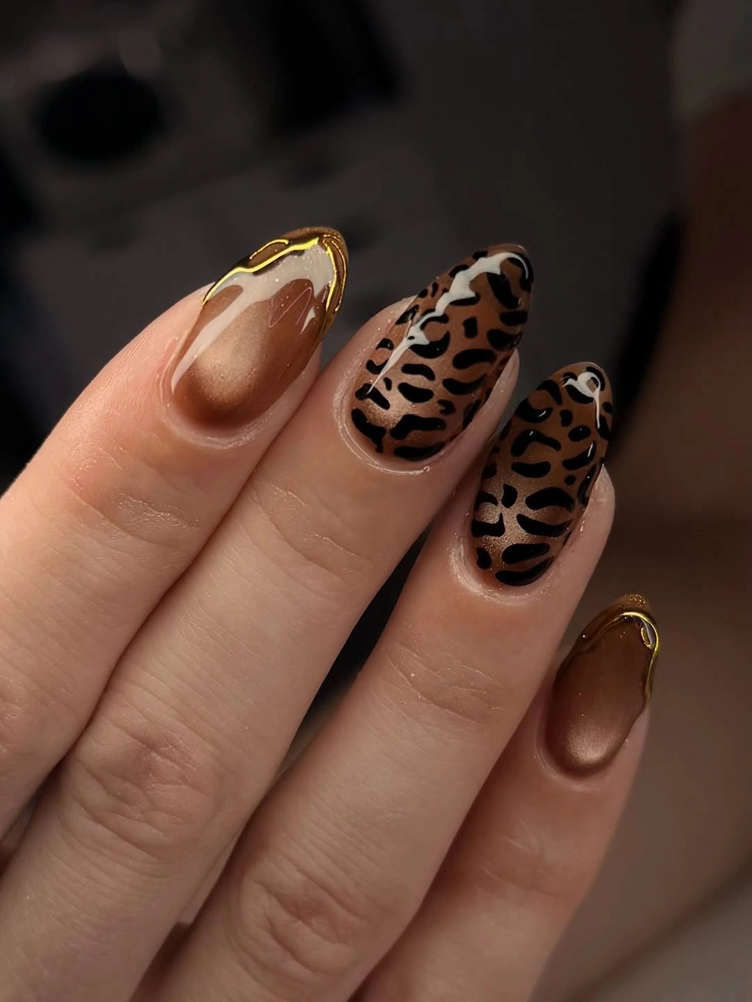 Glossy brown almond nails with leopard style patterning
