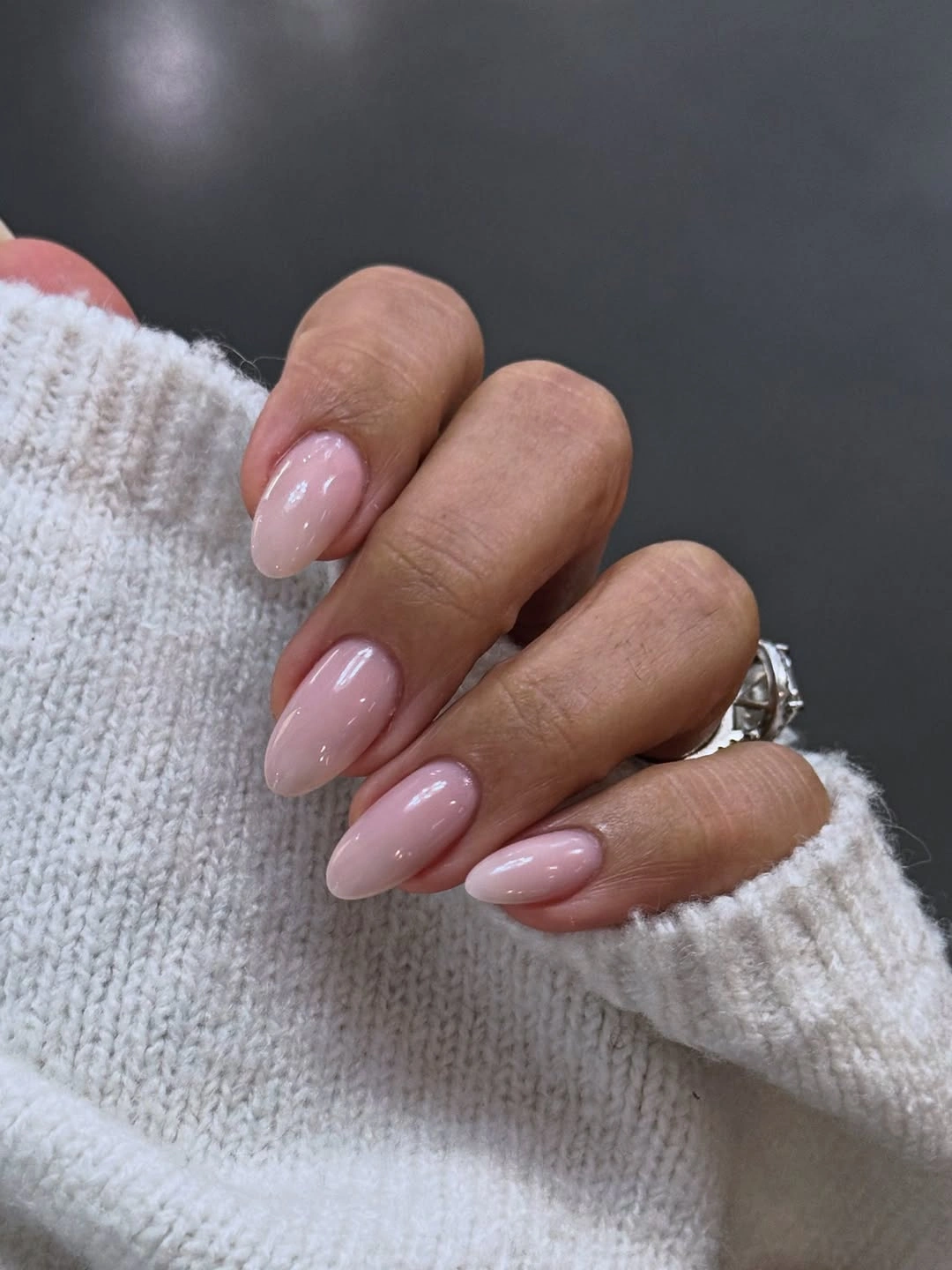 Clean sheer blush almond nails with glossy finish