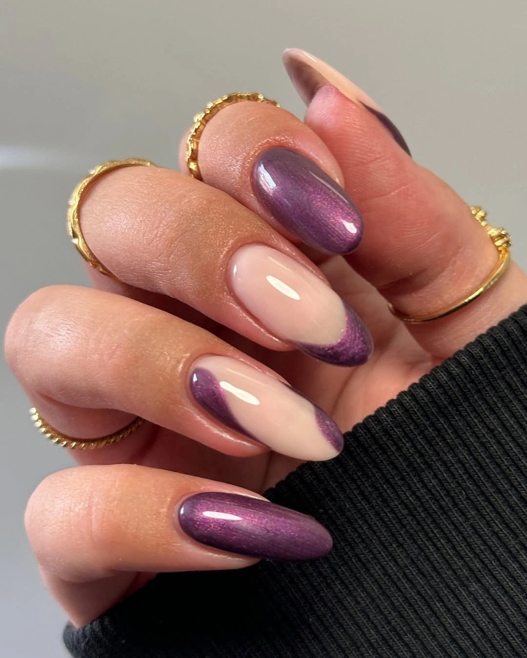 Plum shimmer almond nails with curved negative space