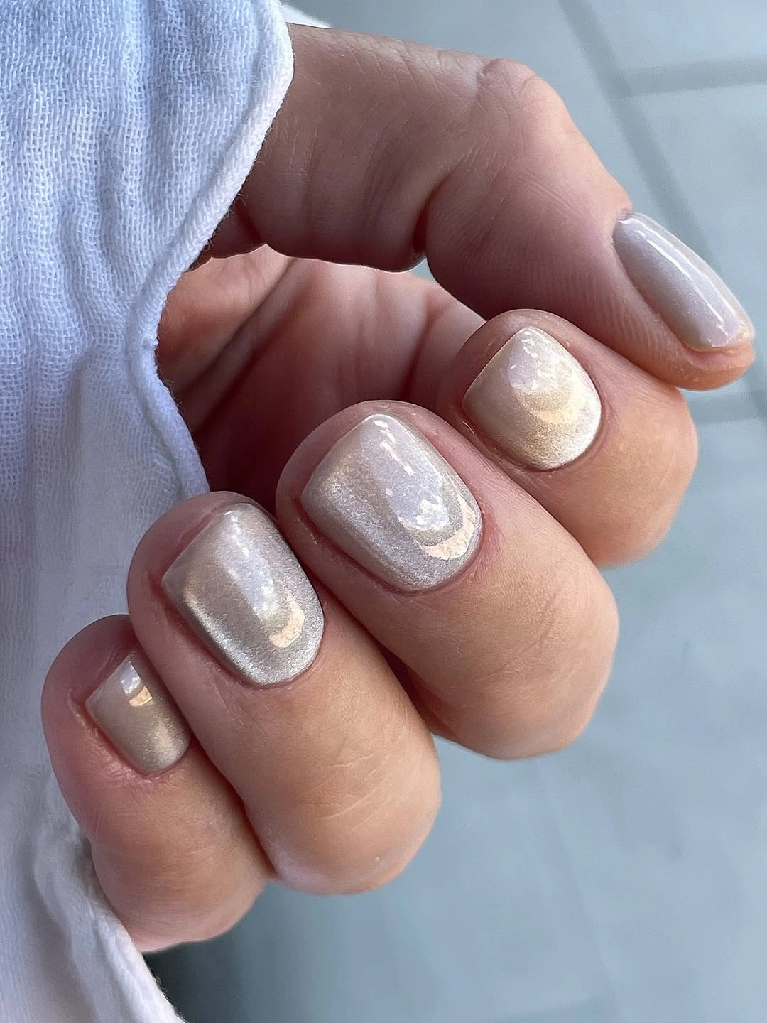 Short pearly champagne square nails with glossy sheen