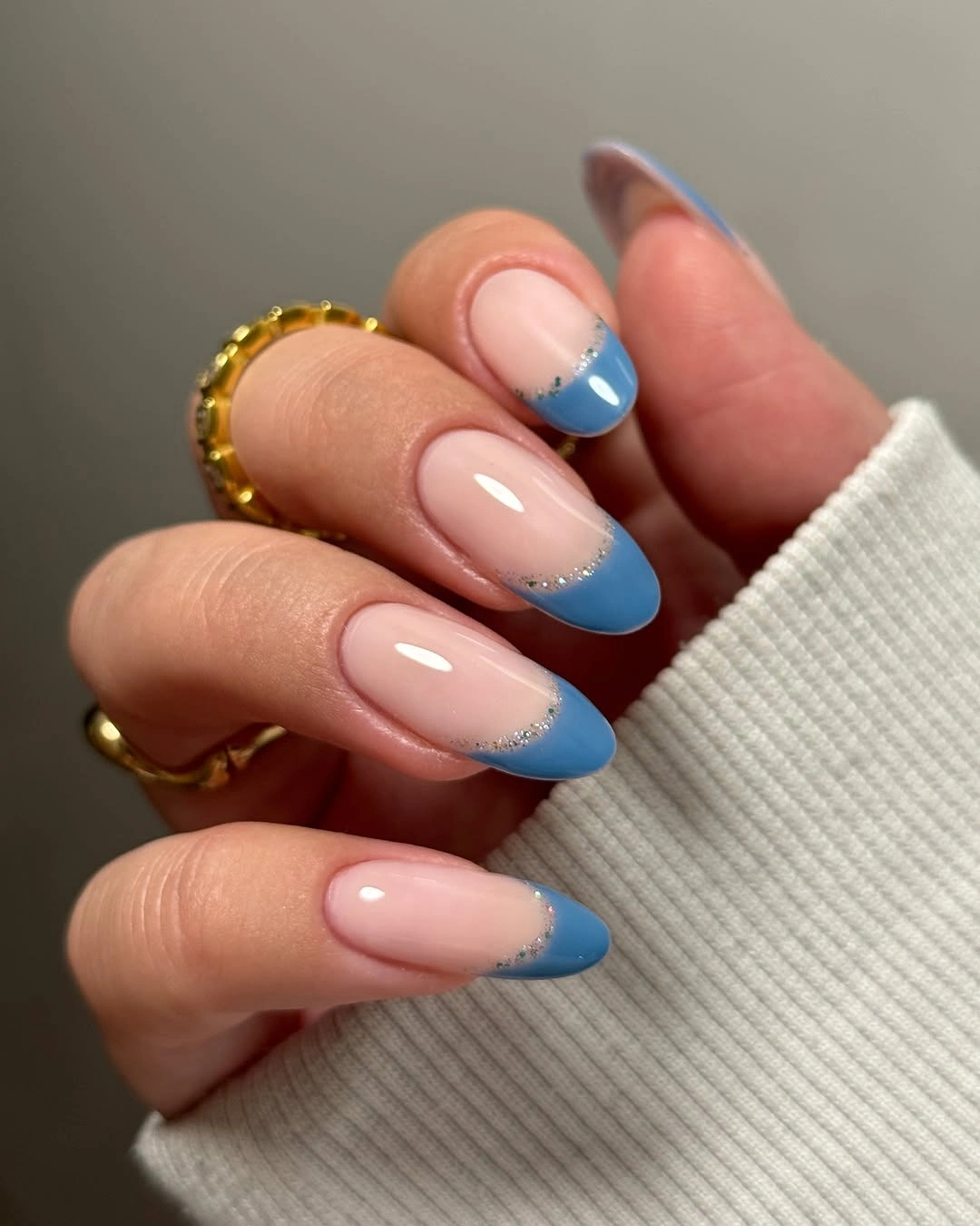 Soft blue French tips with silver glitter arcs