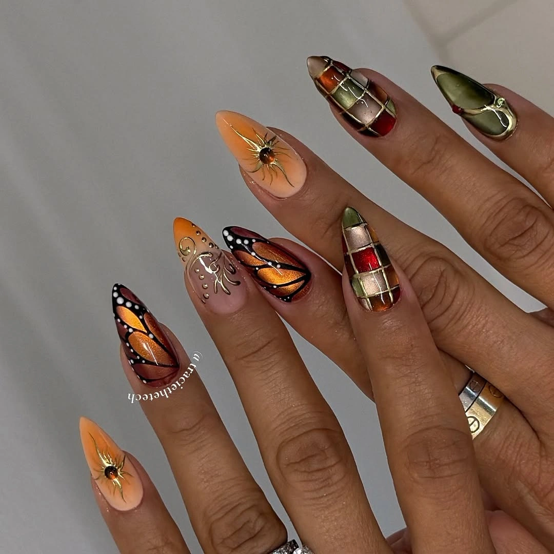 Pointed fall nails with monarch wings and plaid motifs