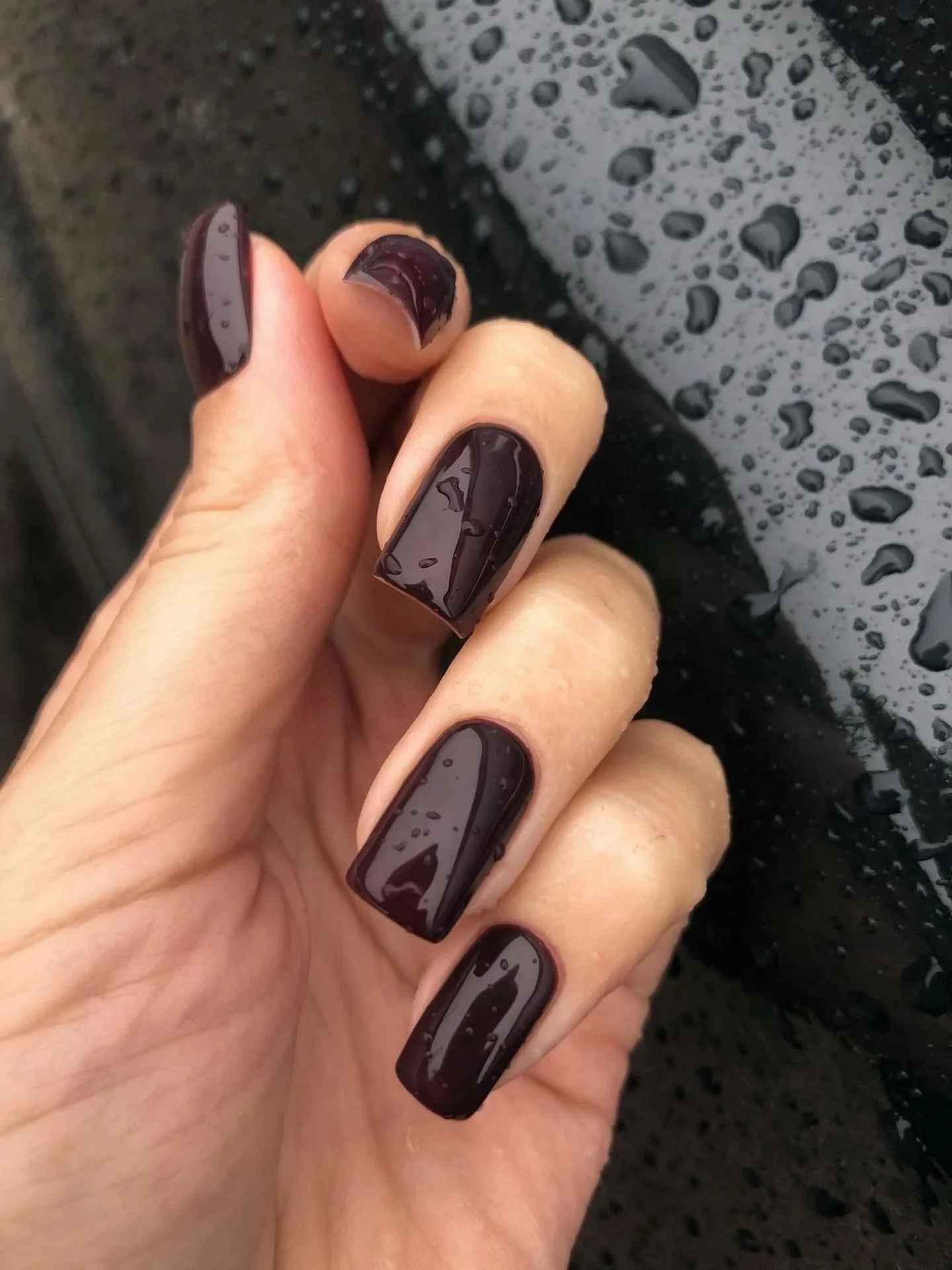 Medium almond nails with olive polish plaid and white dot accents