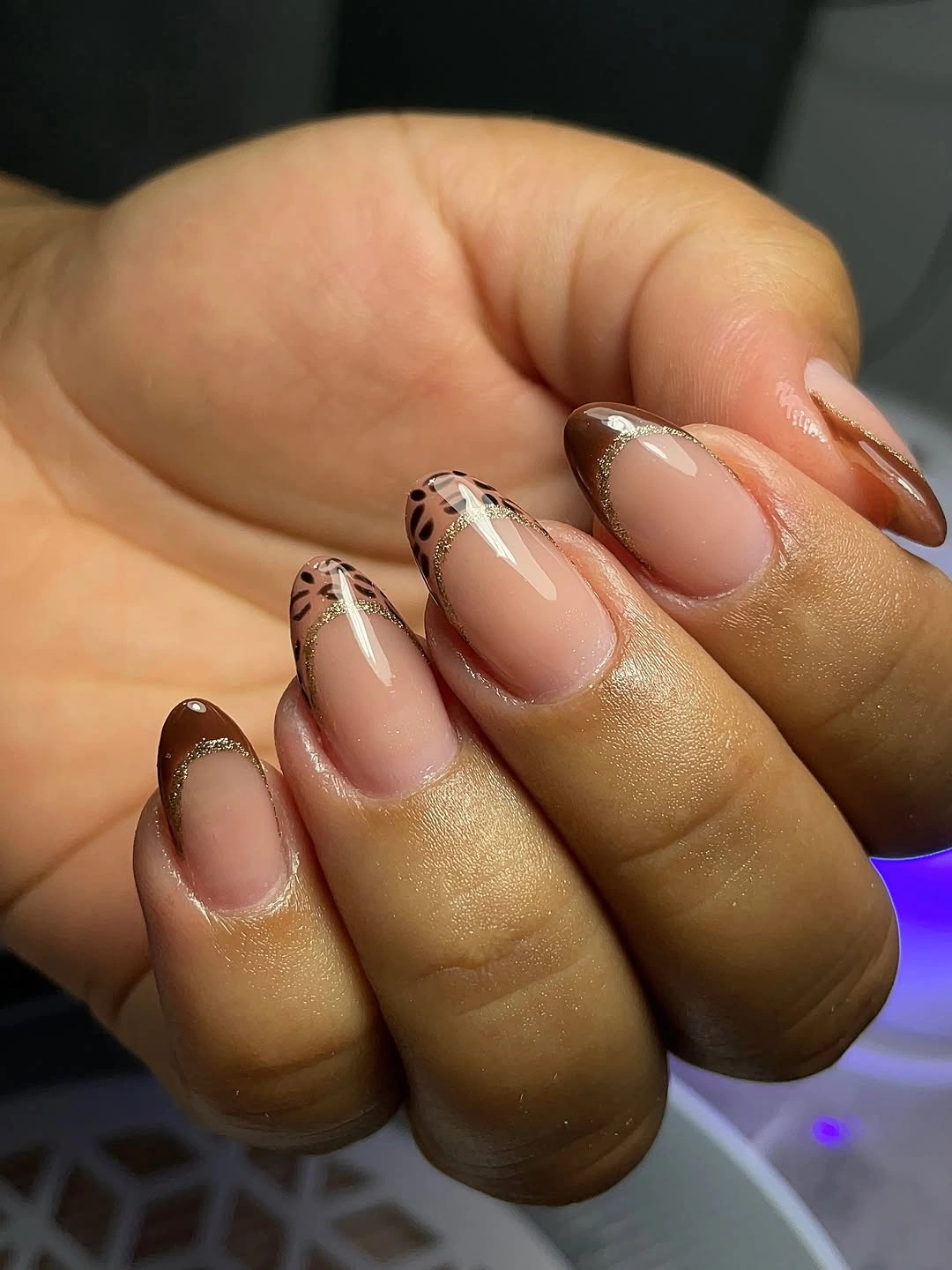 Milky white rounded nails with brown organic patch accents