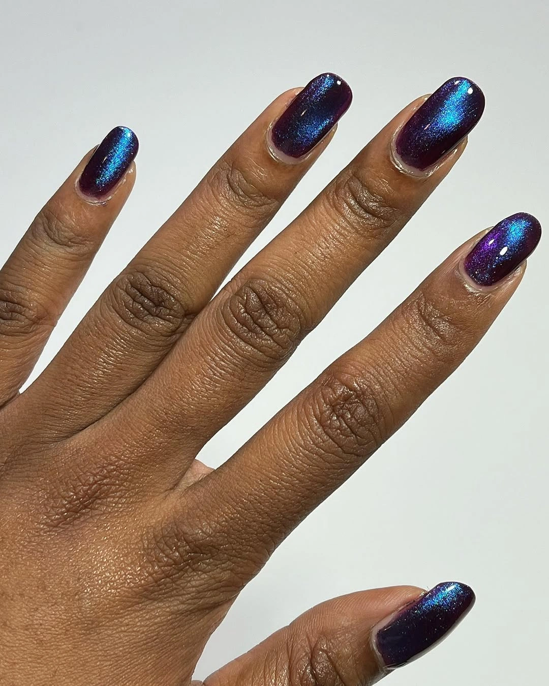 Long almond nails with deep purple-blue reflective centers