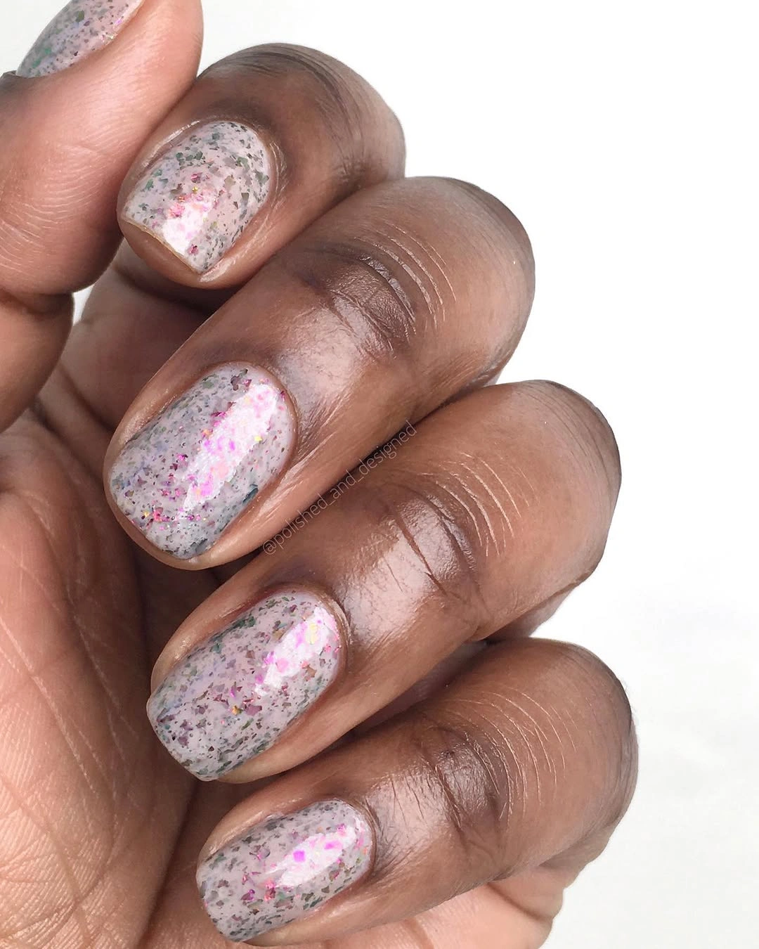 Short rounded-square nails with pearly pink-white speckles