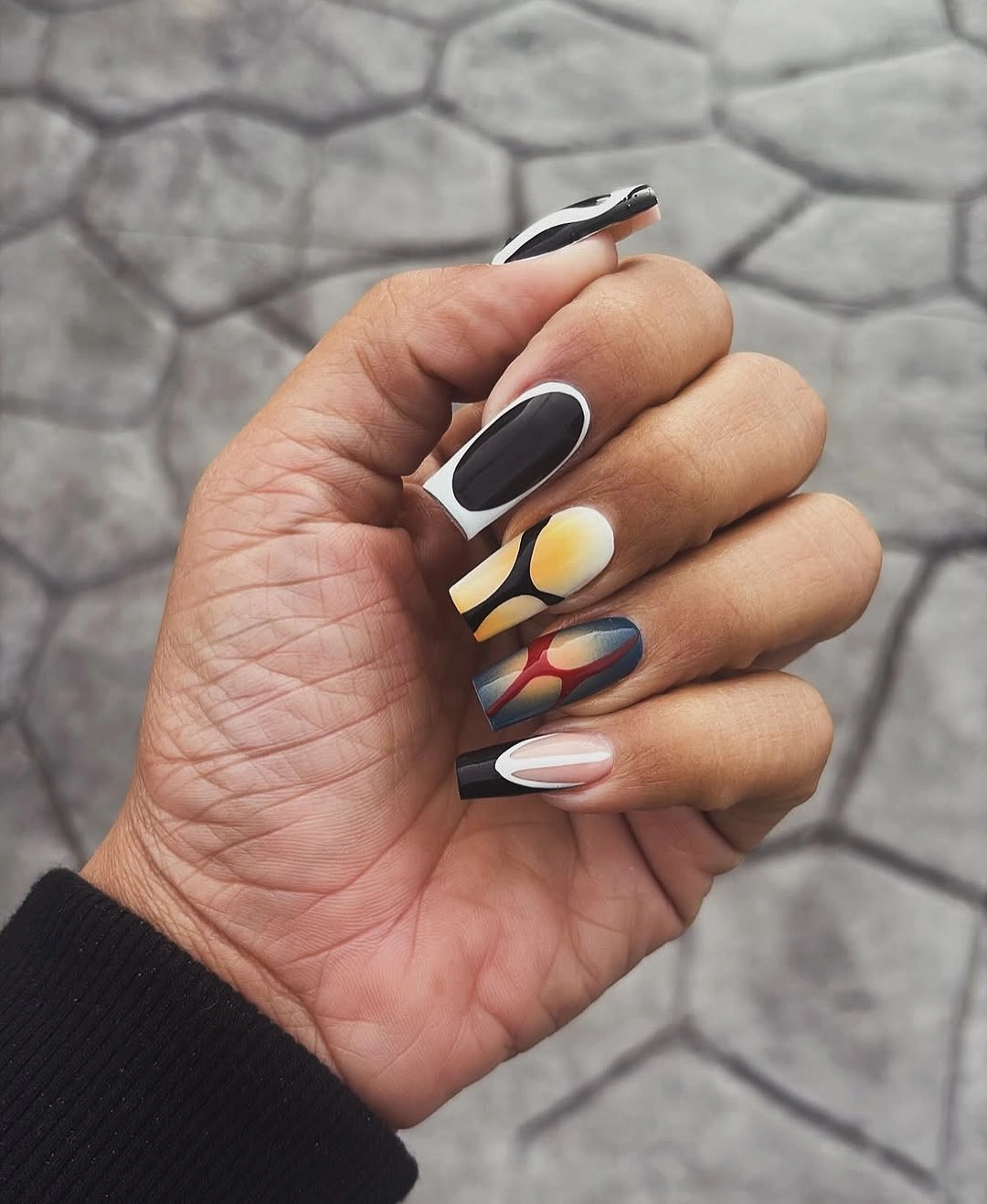 Medium nails with black white yellow green red and blue graphic blocks