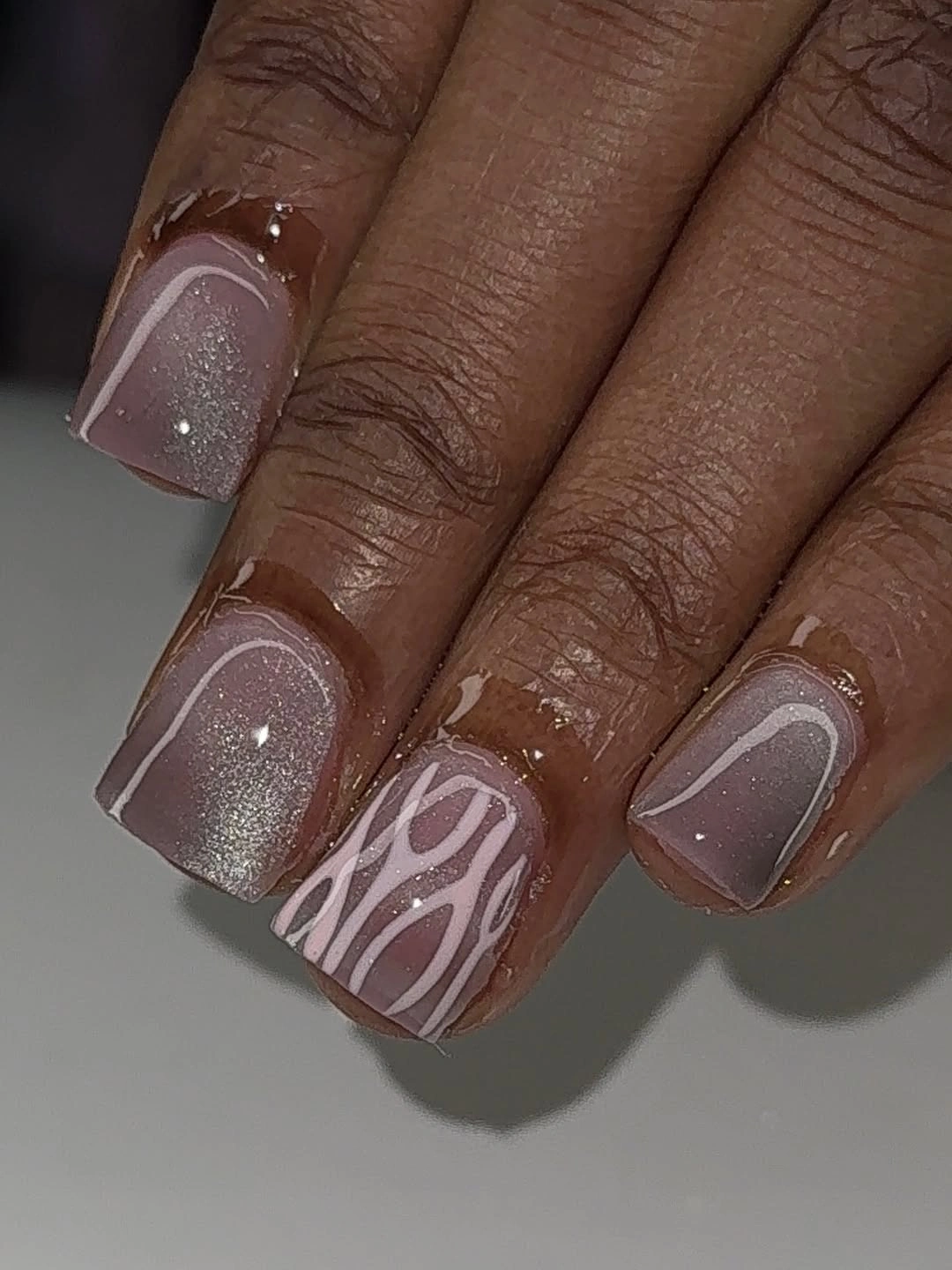 Short square mauve-gray nails with thin white abstract lines