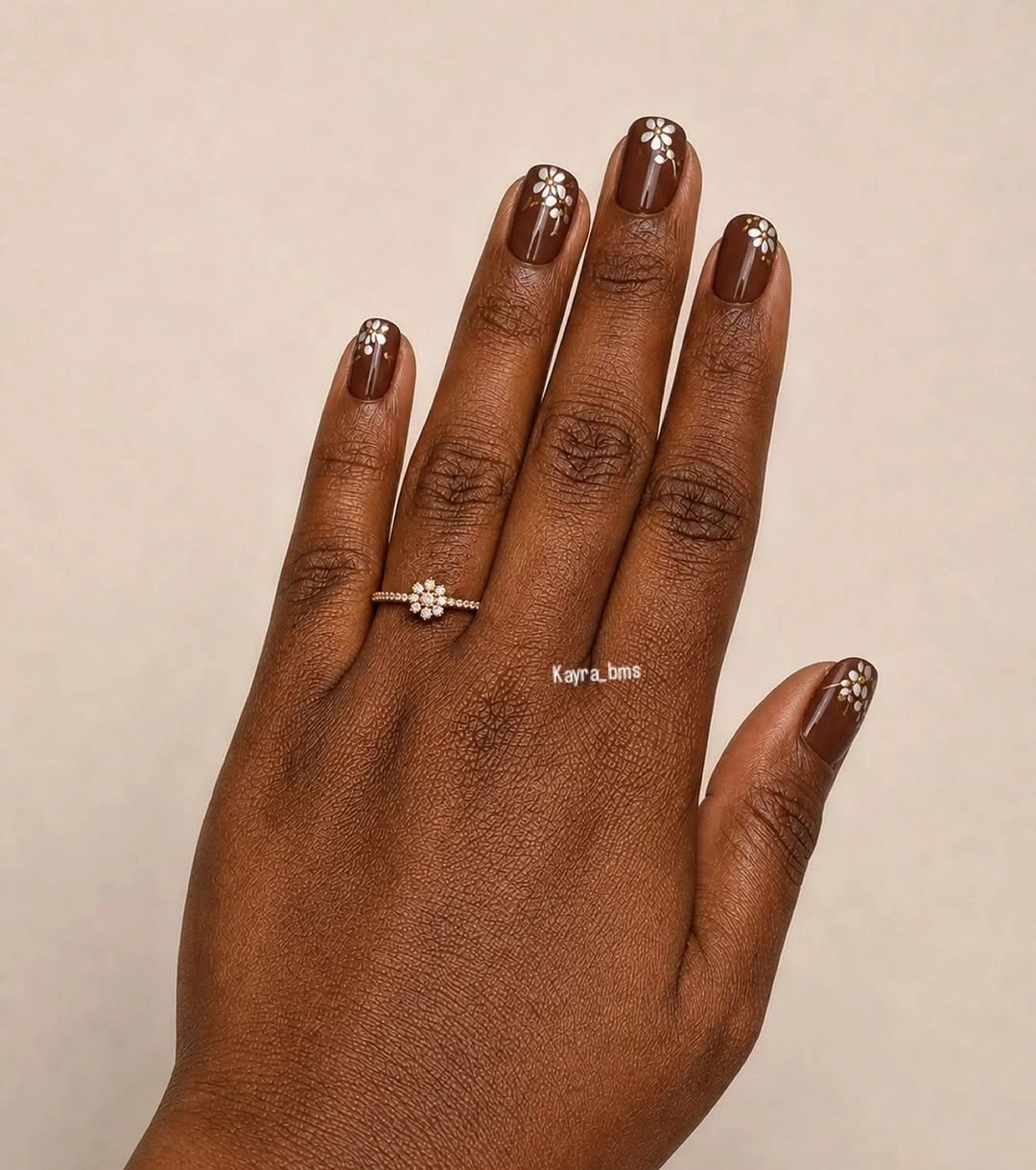 Glossy chocolate-brown almond nails in a deep autumn shade