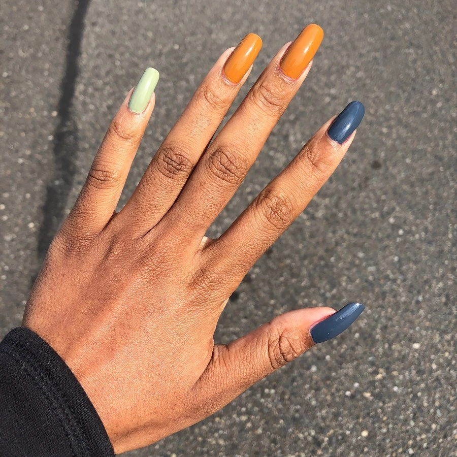 Medium nails with vivid orange, lime green, and dark blue color blocks