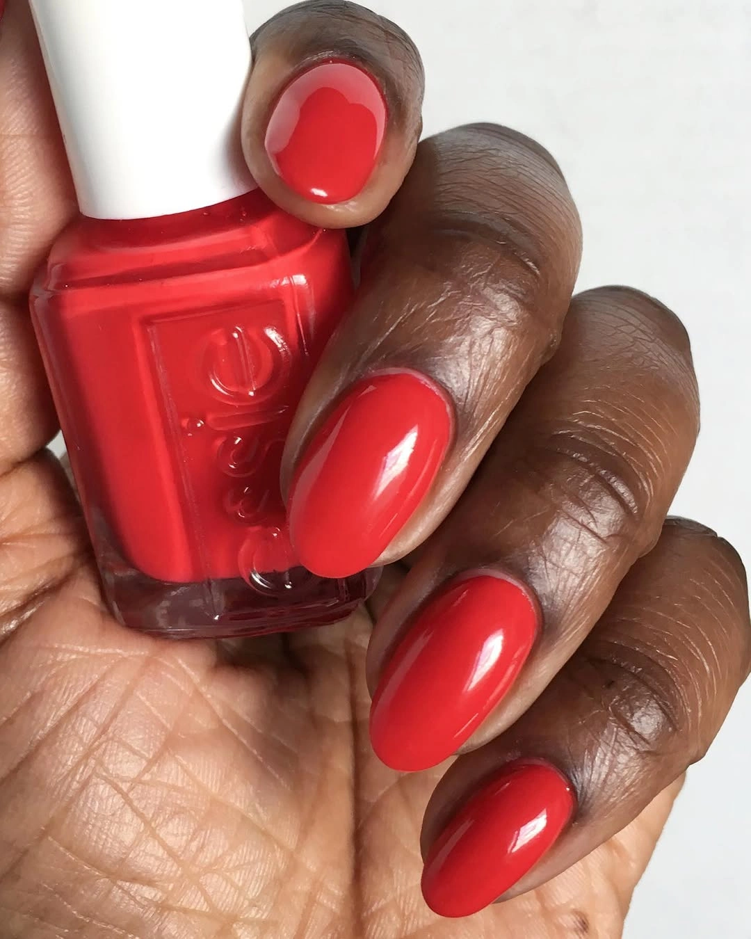 Rounded medium nails in a saturated glossy red autumn shade