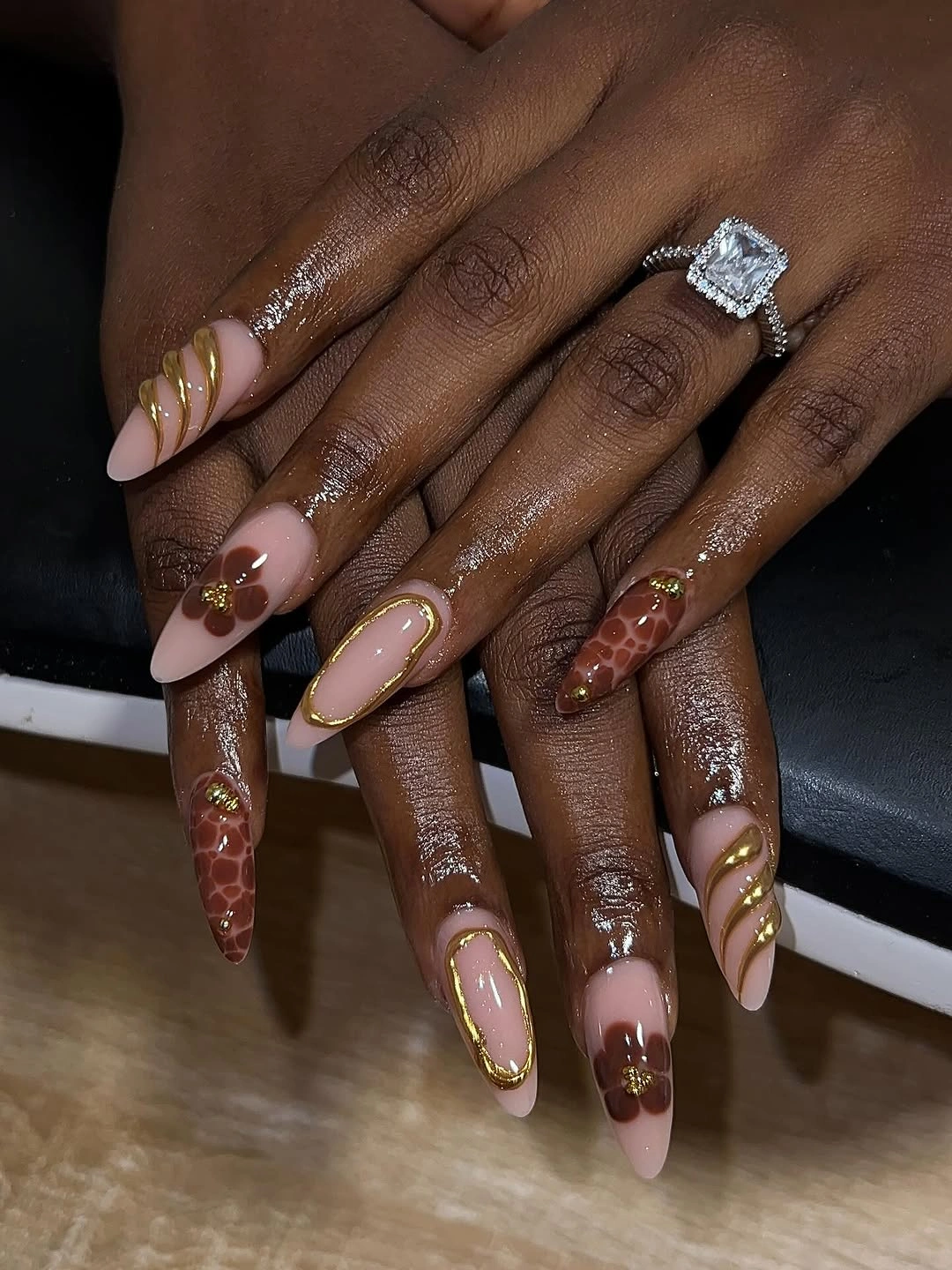 Brown floral nude nails with gold border accents