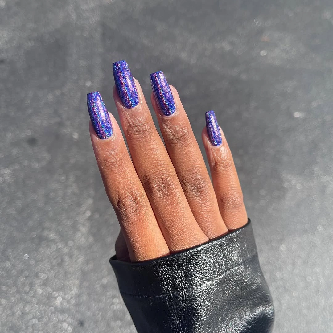 Blue violet glitter square nails in sunlight