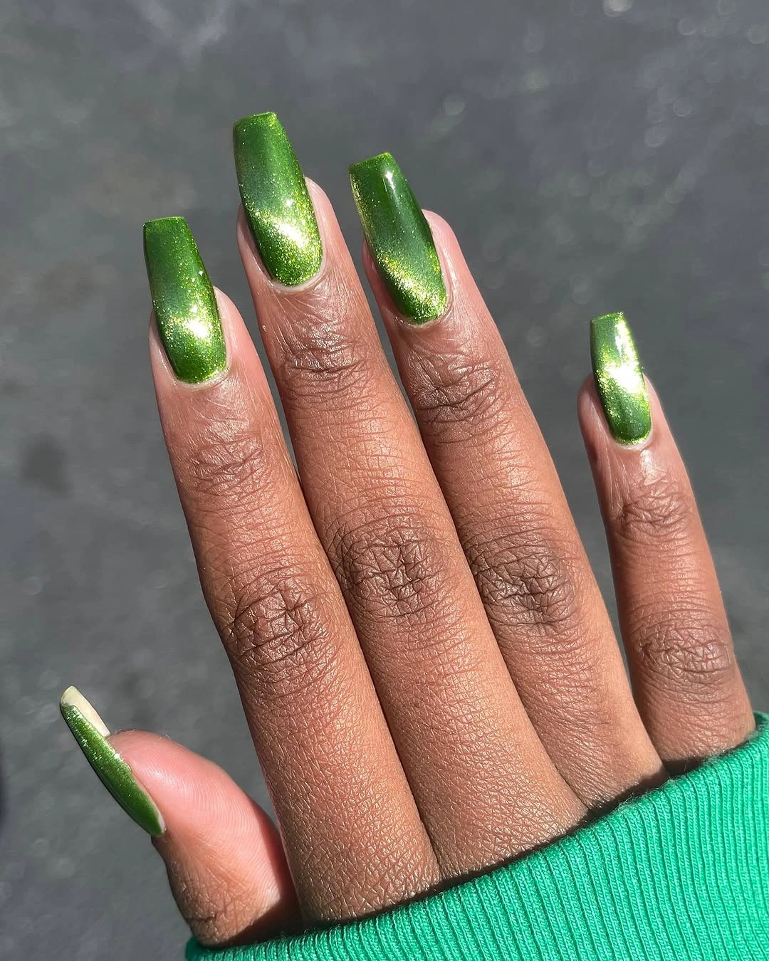 Metallic green square nails with gold shifting shine