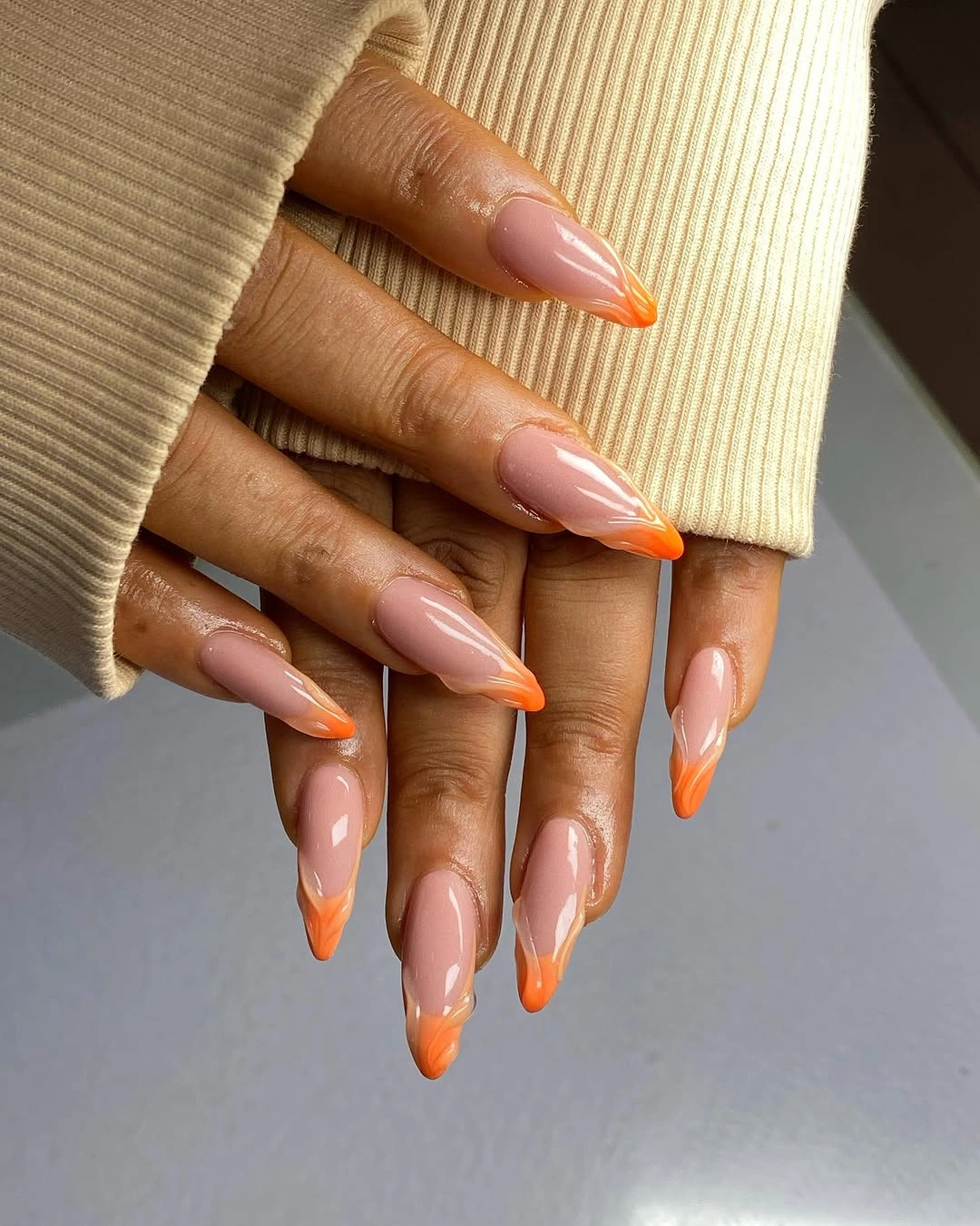 Long almond nails with orange flame French tips