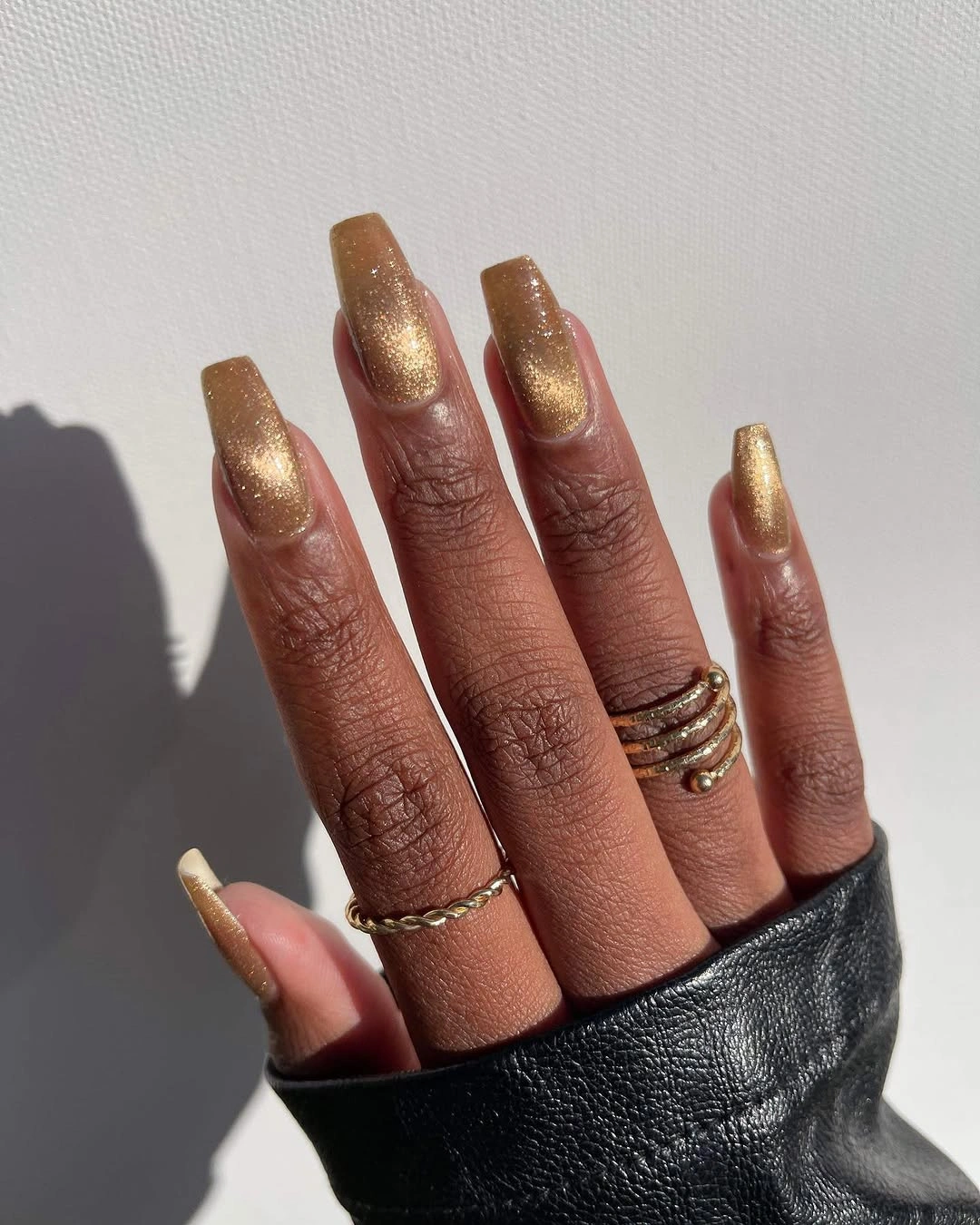 Bronze gold glitter coffin nails on dark skin