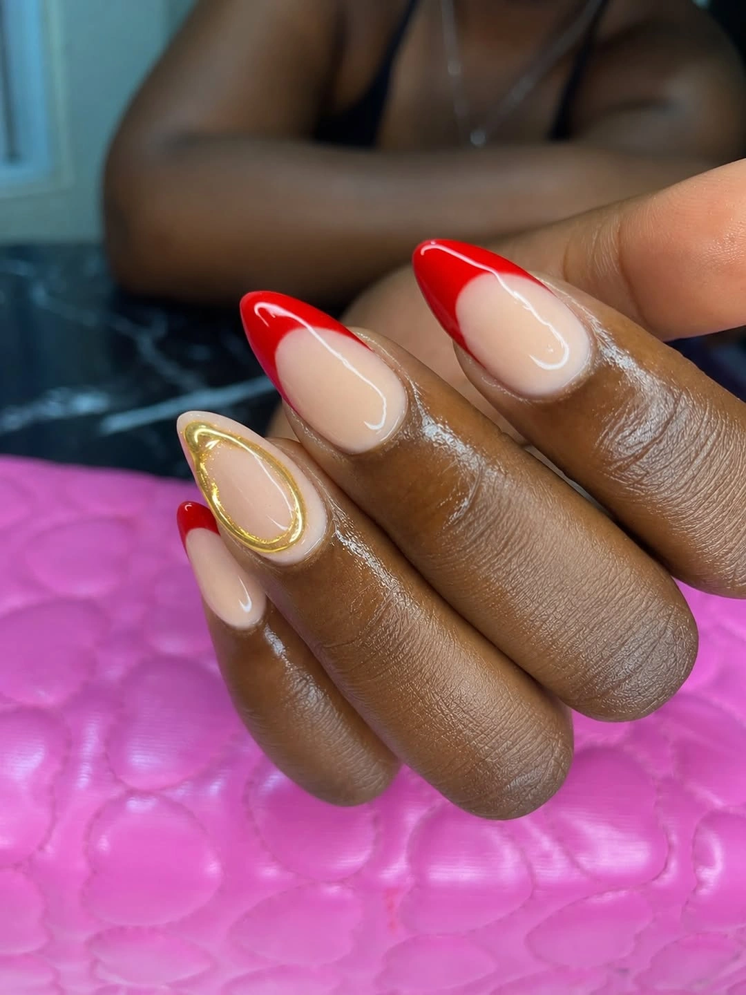 Red French almond nails with gold outline accent