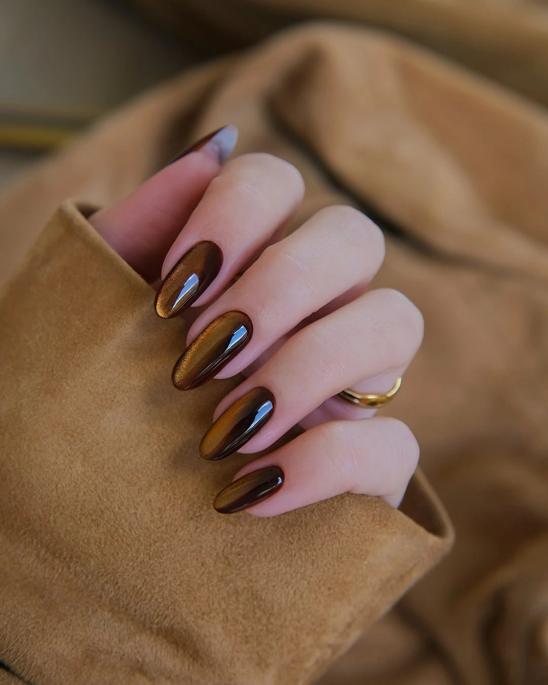 Mauve almond nails with elongated dark metallic brown center panels