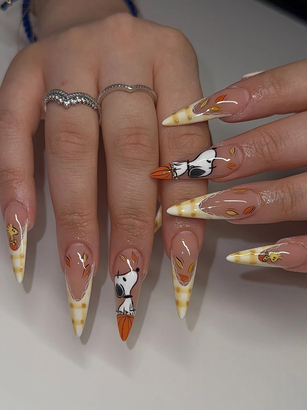 Long nude pointed nails with white tips orange fox illustrations and leaf details