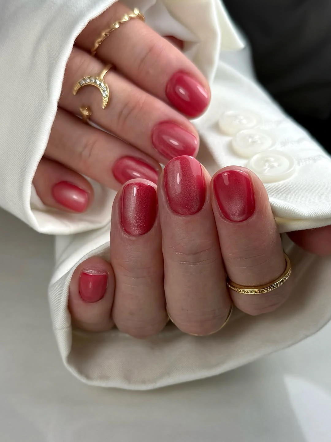 Short oval nails in a glossy muted raspberry red shade