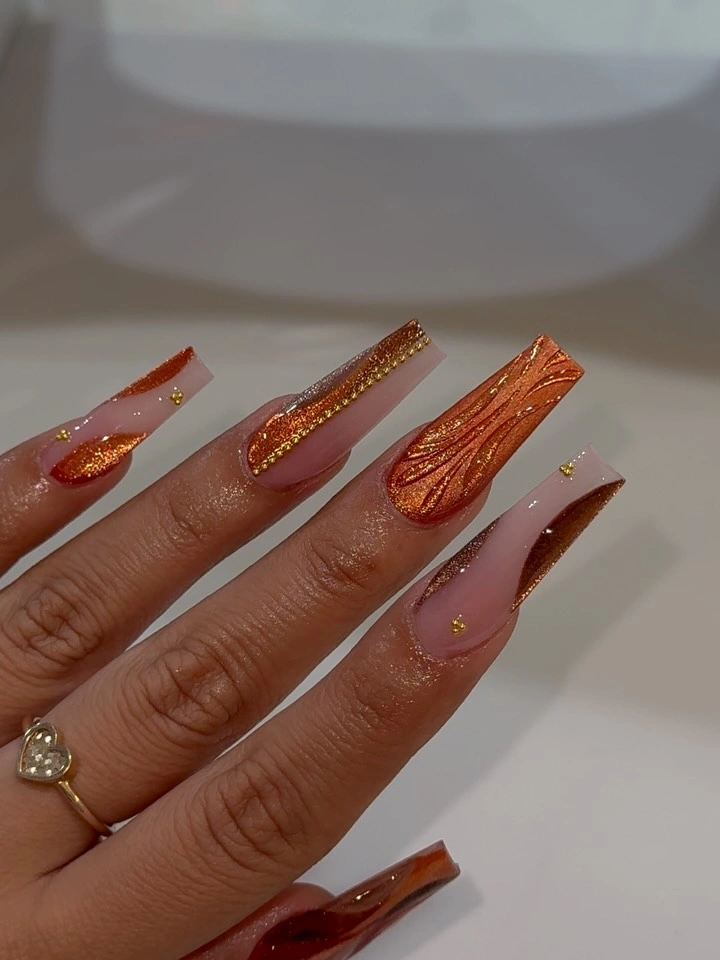 Long clear square nails with copper edges swirls and gold flecks