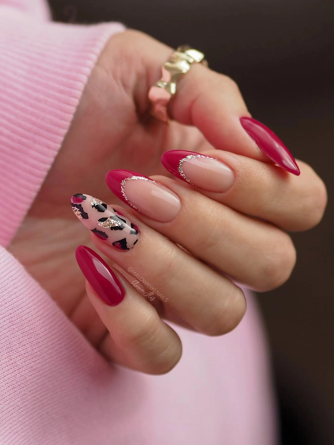 Long almond nails with red French tips and one spotted accent