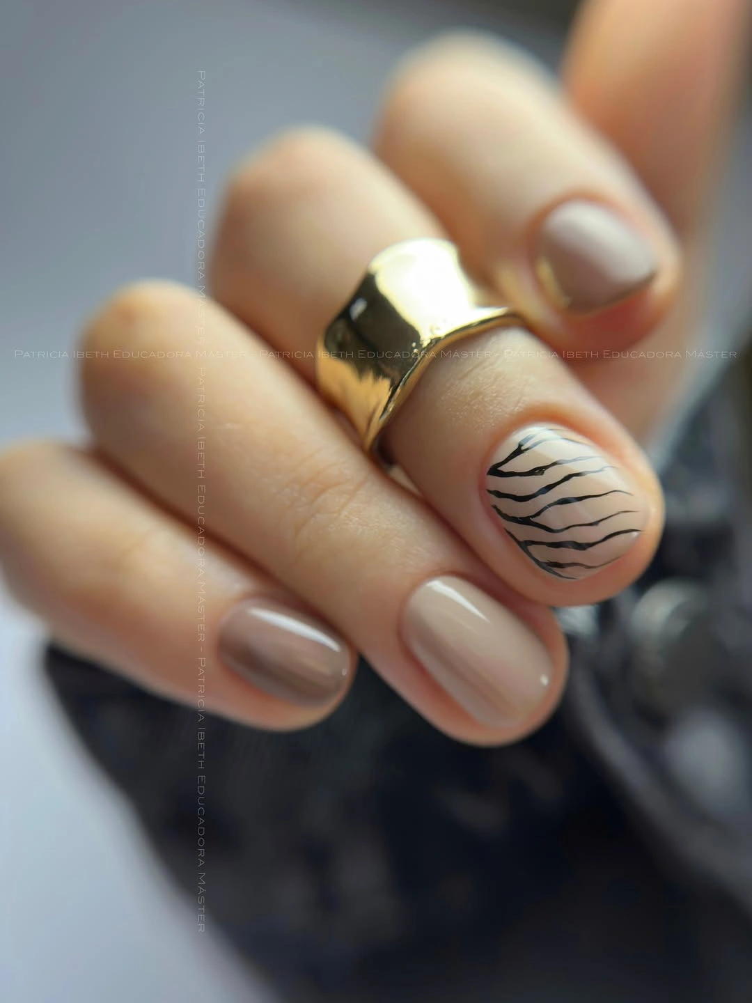 Short neutral beige nails with one off-white black botanical accent