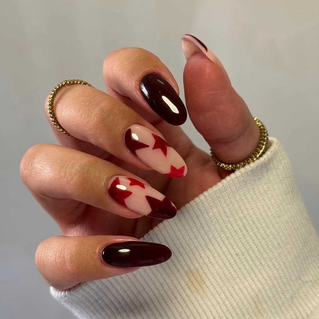 Oxblood almond nails with cream abstract shapes on nude accents