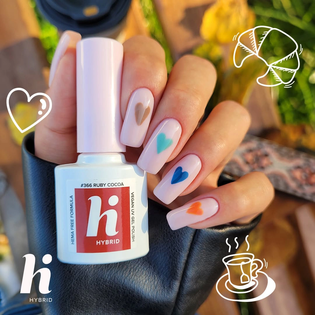 Pale pink square nails with tiny teal blue and orange heart details