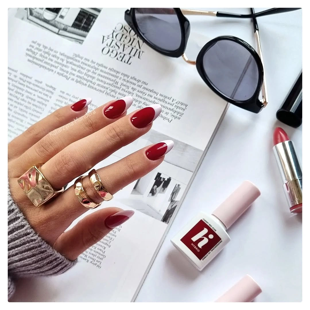 Medium almond glossy cranberry red nails with warm knit styling