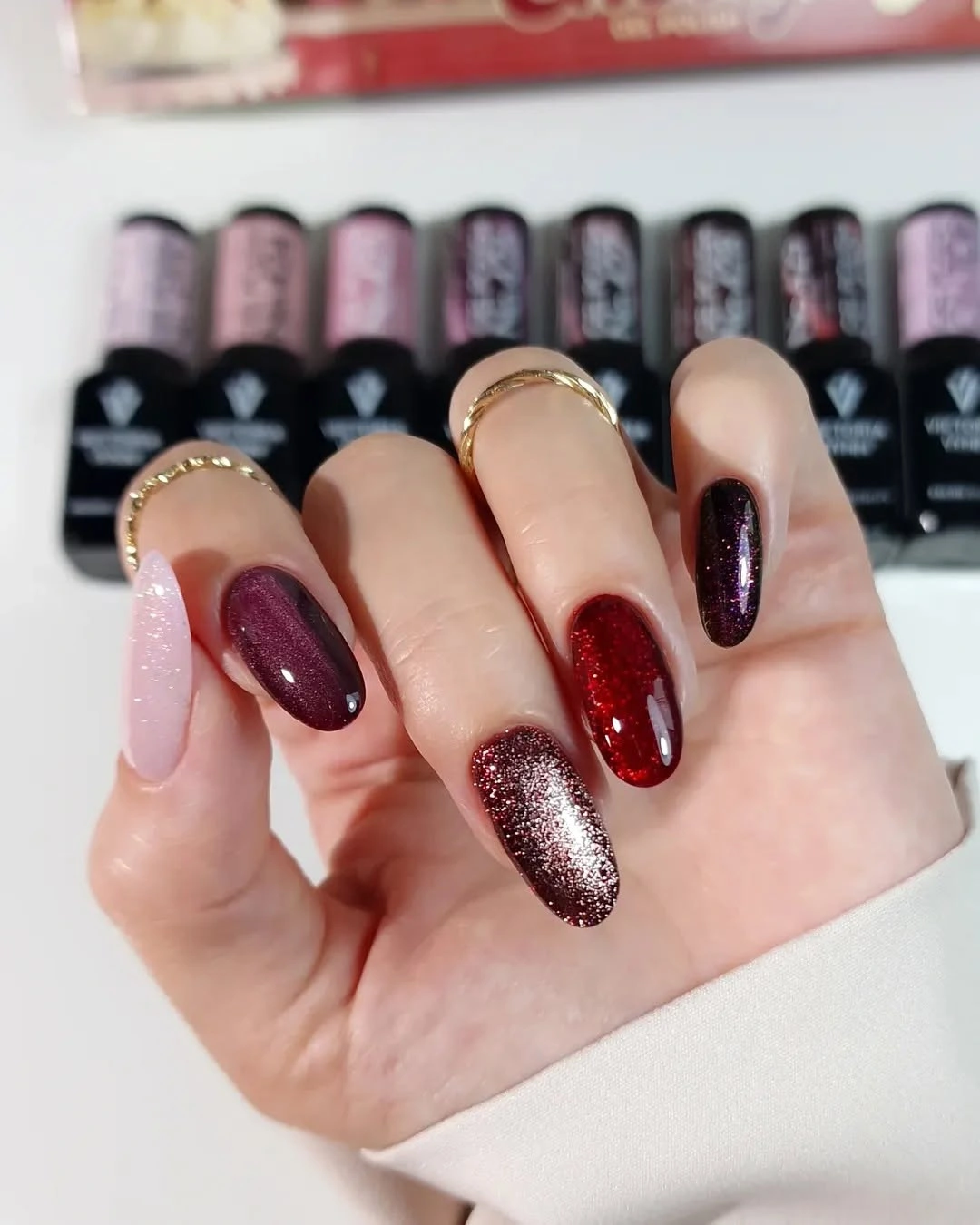 Long burgundy almond nails with pale pink and glitter accent nails
